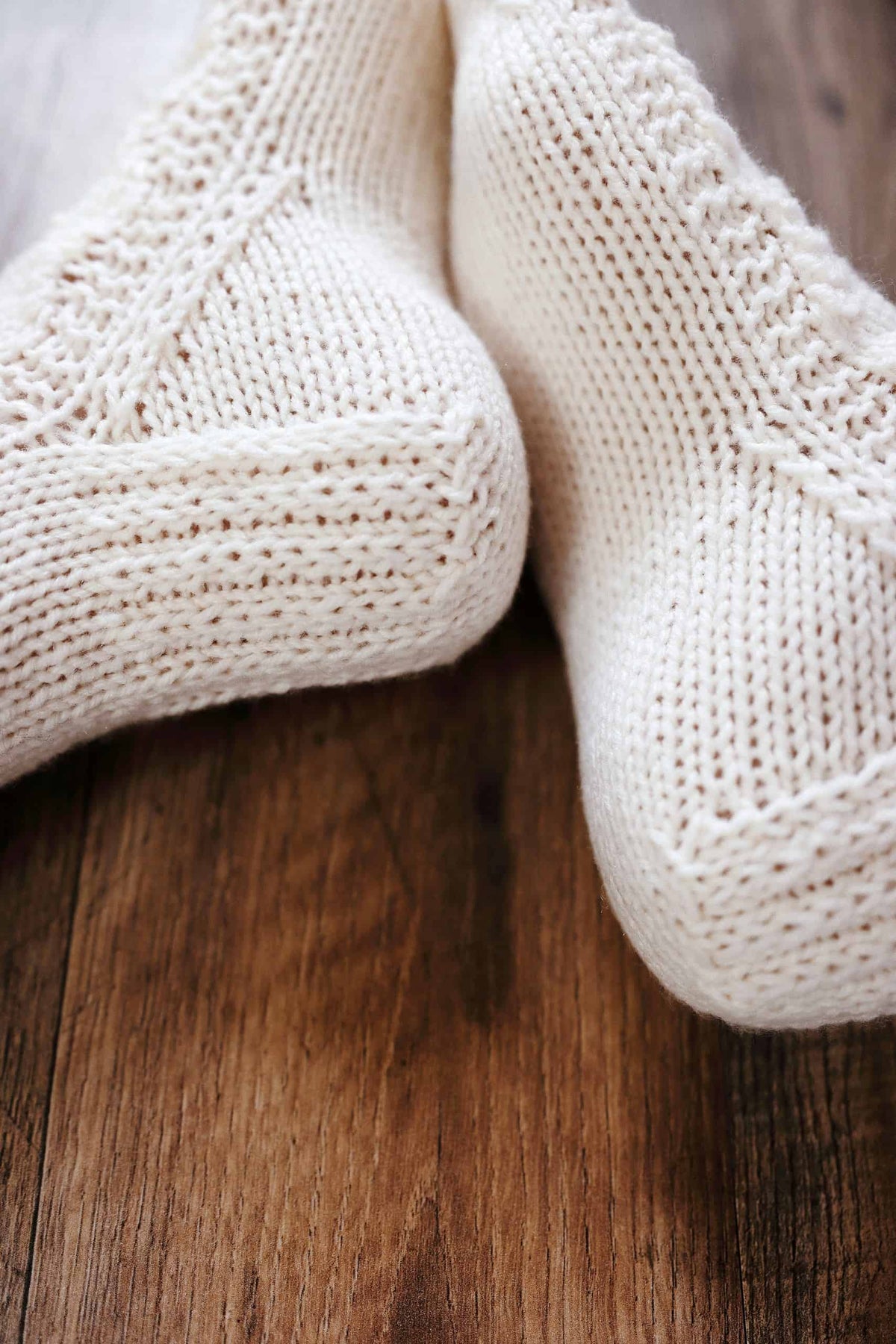 Woman wearing cream colored lace socks knitting pattern The Juniper