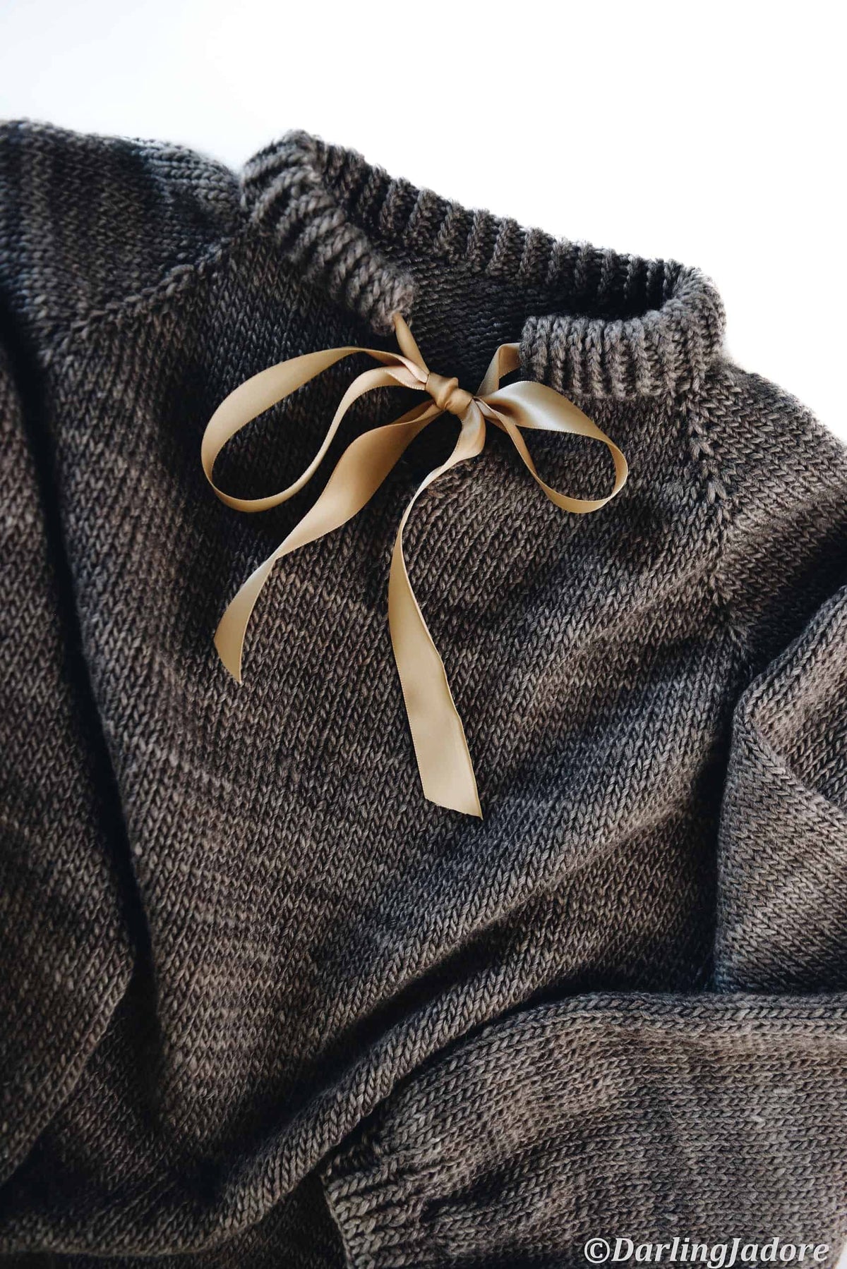 Side view of handknit Posy sweater showing seamless raglan construction and elegant drape