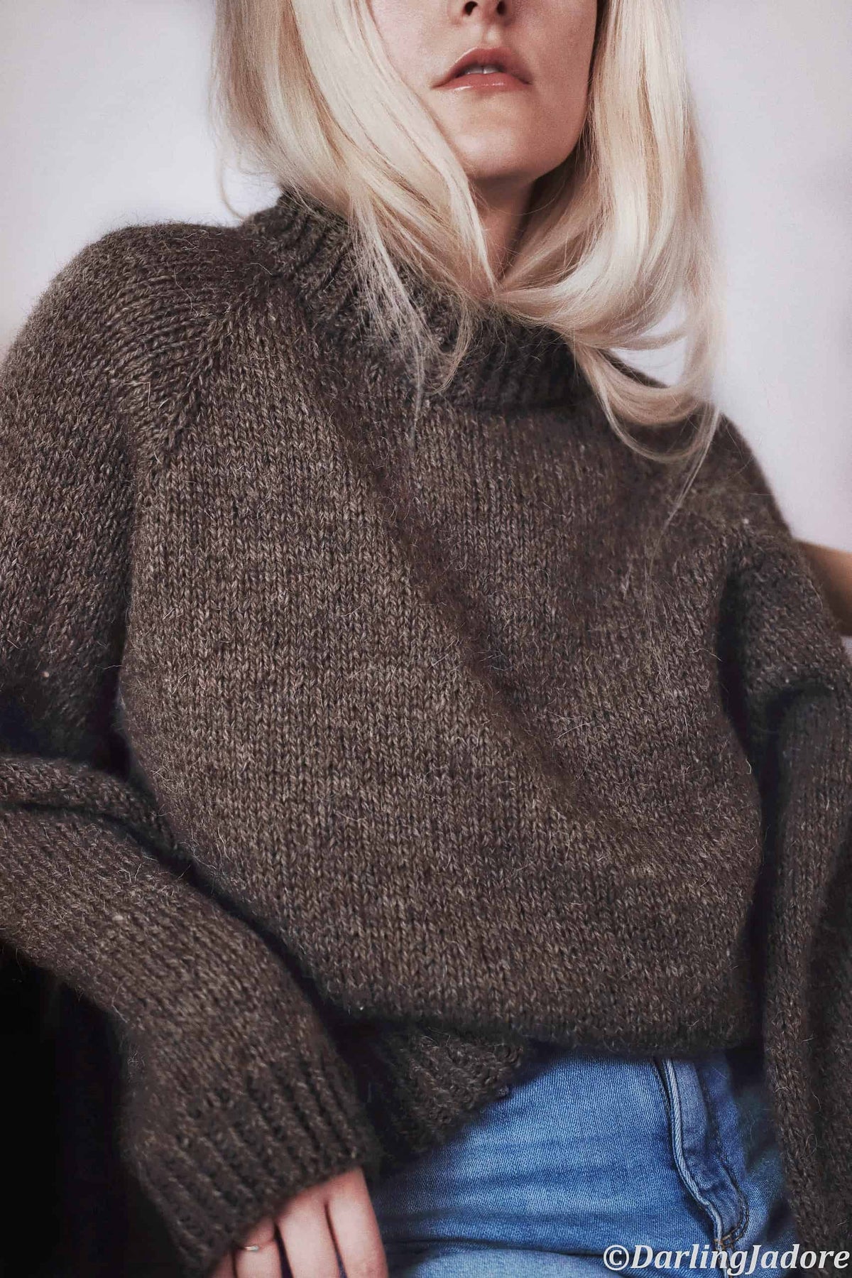 Minimalist raglan sweater knitting pattern with double-knit neck detail in neutral tones