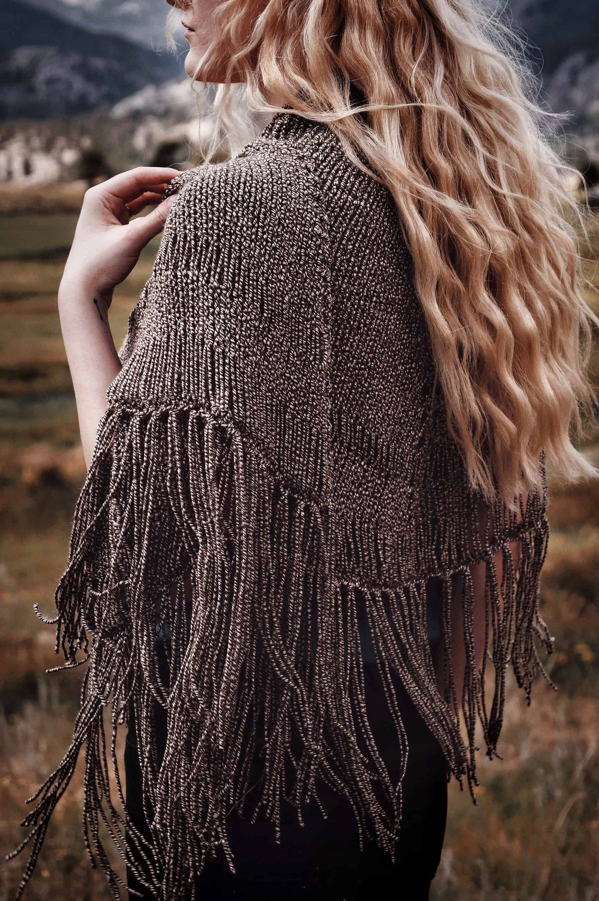 Beige crescent shawl with tassels draped elegantly - beginner lace shawl knitting pattern by Darling Jadore