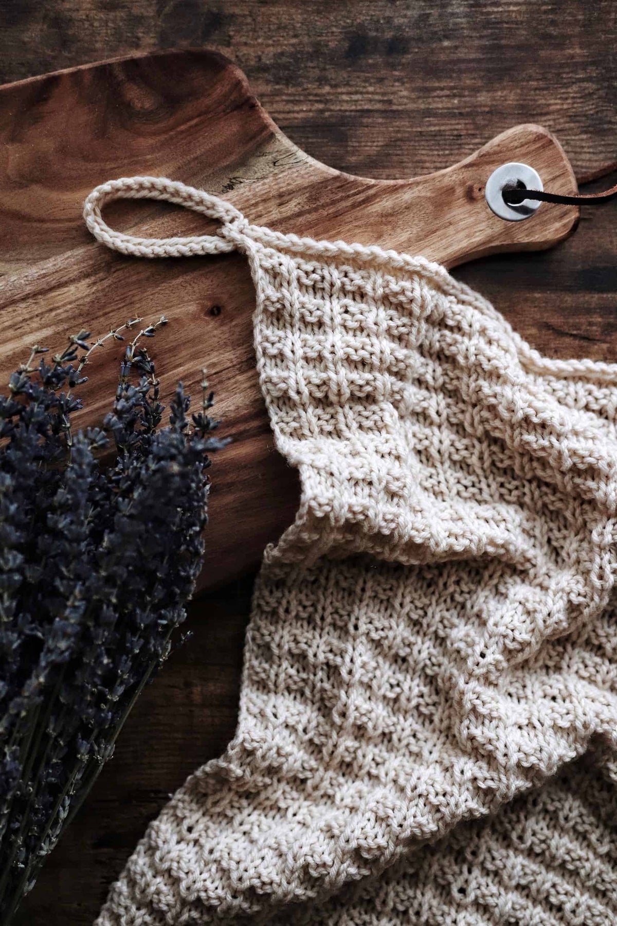 Close up of waffle stitch tea towel knitting pattern texture in cream cotton yarn