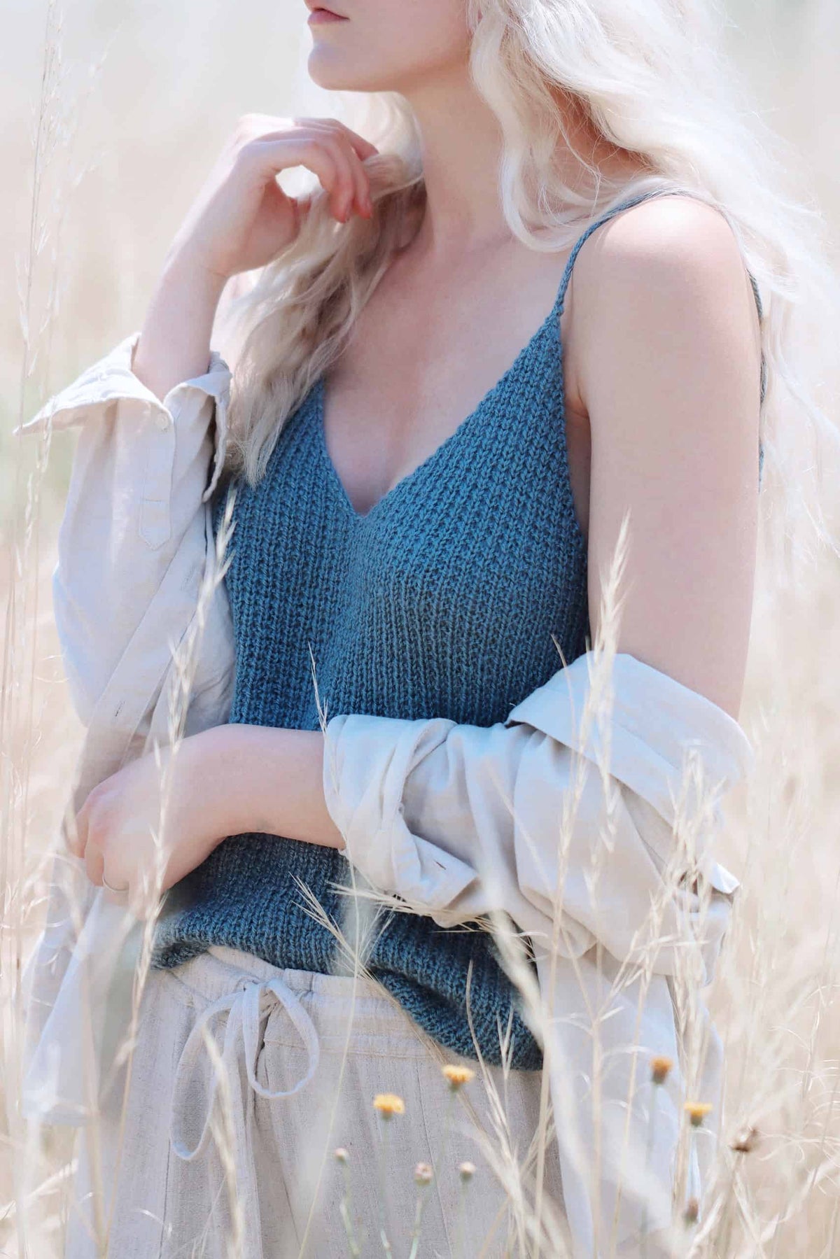 Close up of textured knit and purl stitch pattern on blue camisole knitting pattern