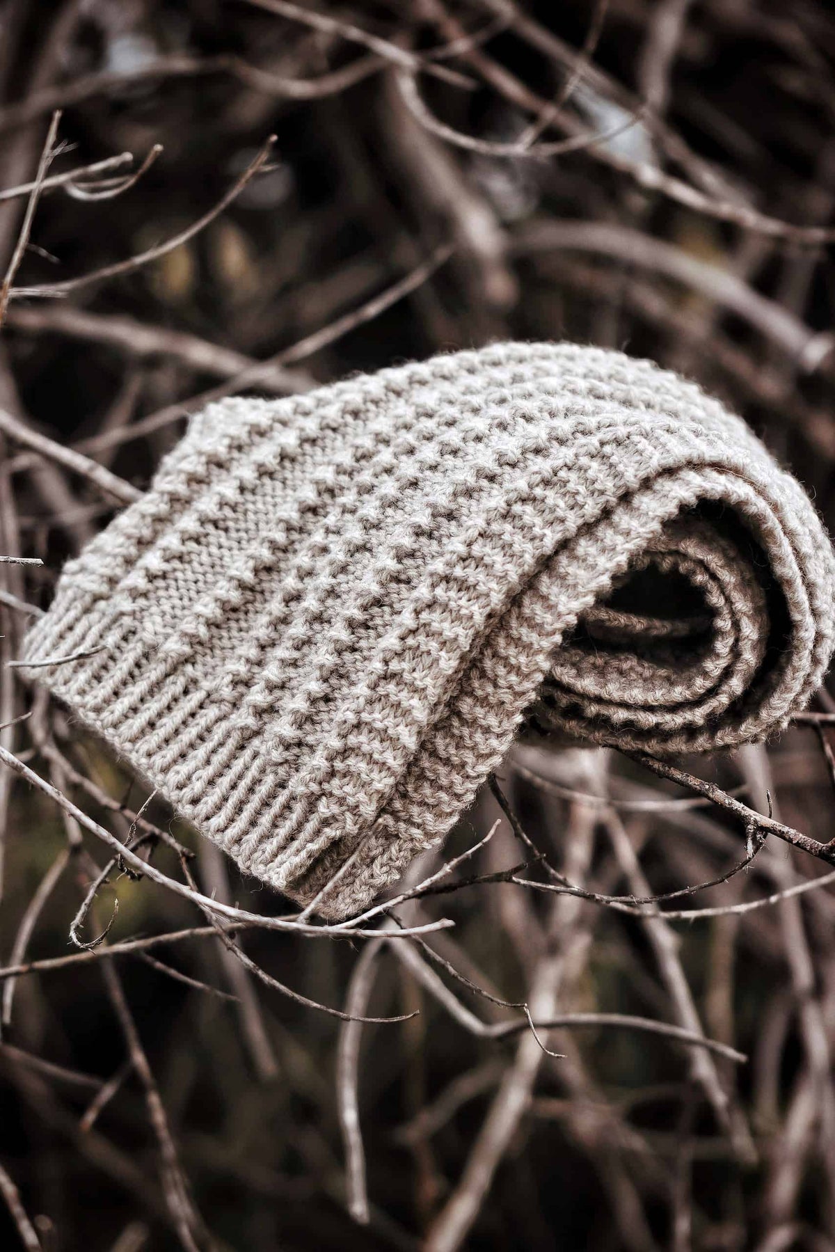 Textured ribbed scarf knitting pattern detail in charcoal wool yarn