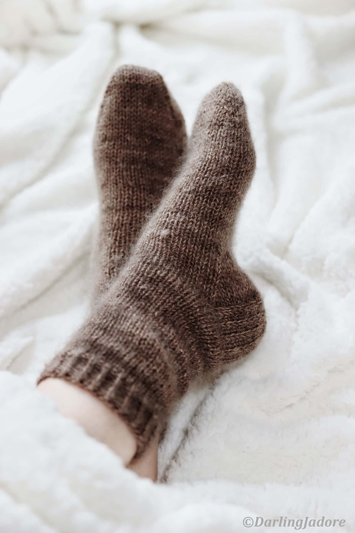 Beginner-friendly feather socks knitting pattern with cozy mohair yarn in natural brown tones