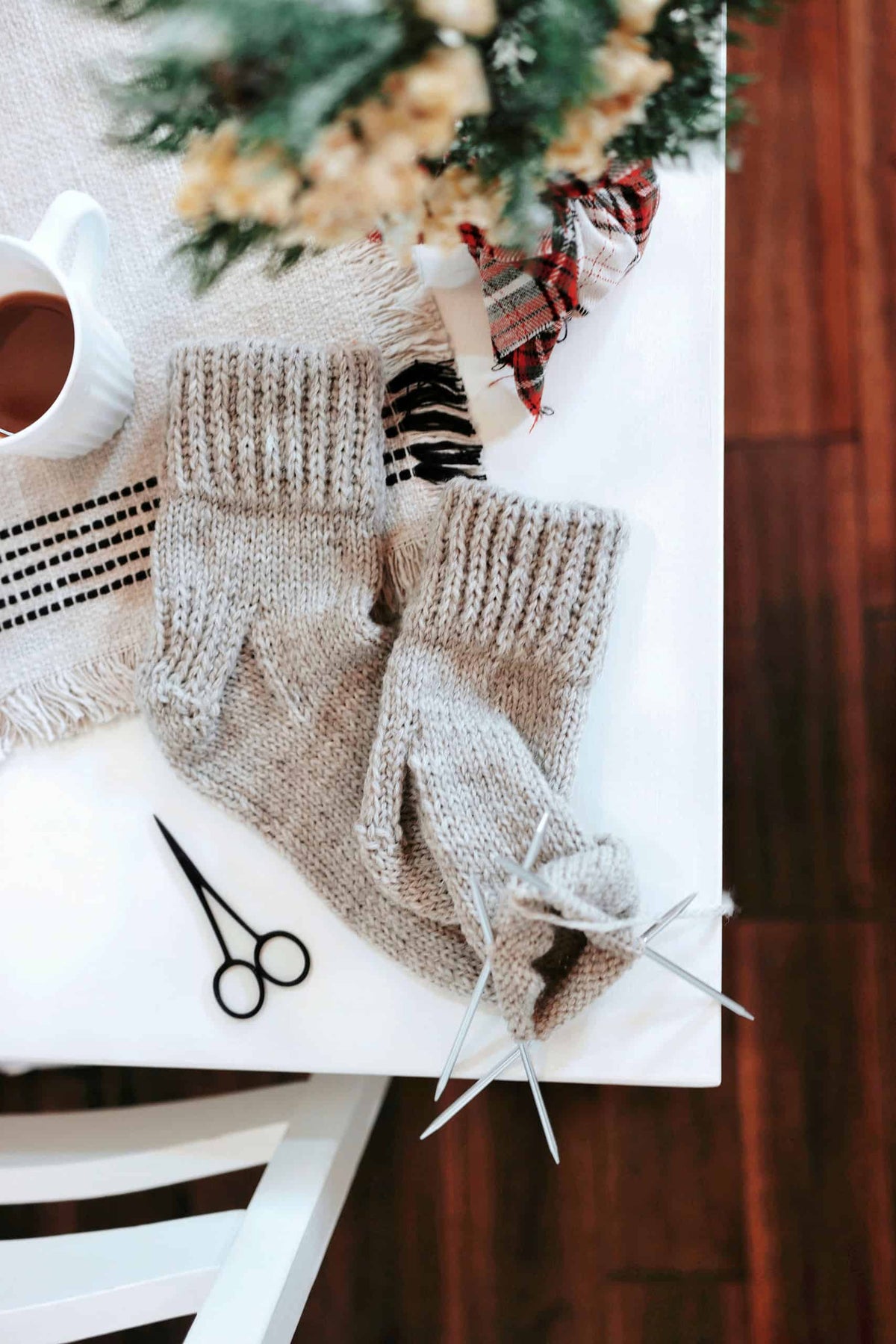 Easy knit socks pattern in worsted weight yarn displayed on rustic wooden surface