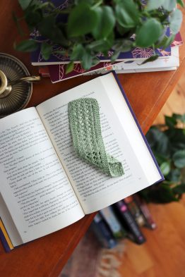 Vintage lace knit bookmark with delicate pattern detail on open book