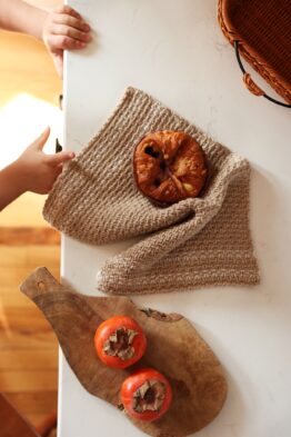 Cream knitted farmhouse tea towel with textured stitch pattern - Homestead Towel knitting pattern by Darling Jadore