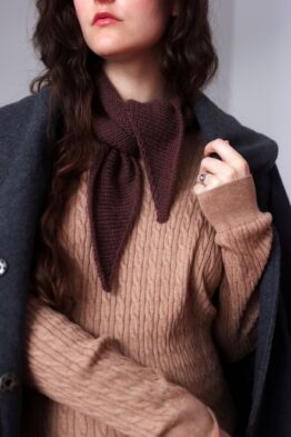 Lightweight bandana scarf knitting pattern draped elegantly around neck in natural light