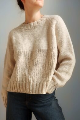 Person wearing a cozy beige sweater